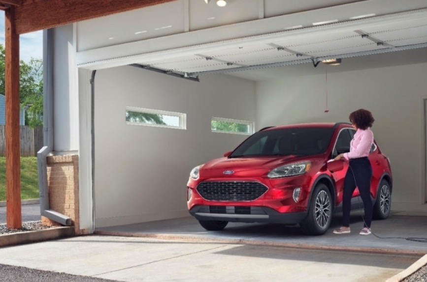 Red 2020 Ford Escape parked inside an open garage