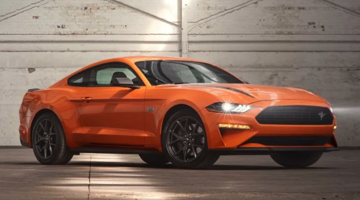 Ford Mustang in orange in a parking garage